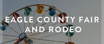 Farris wheel with colorful carts with Eagle County Fair and Rodeo written on top of image