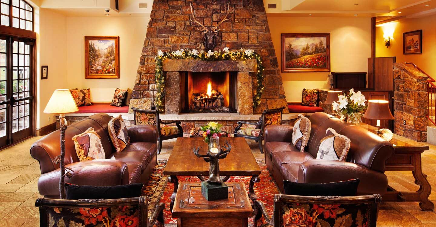 comfortable Colorado style lobby area with couches and fireplace at the Tivoli Lodge Vail Colorado