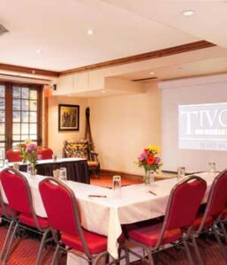 meeting space set up with chairs, tables, and projector screen Tivoli Lodge Vail Colorado