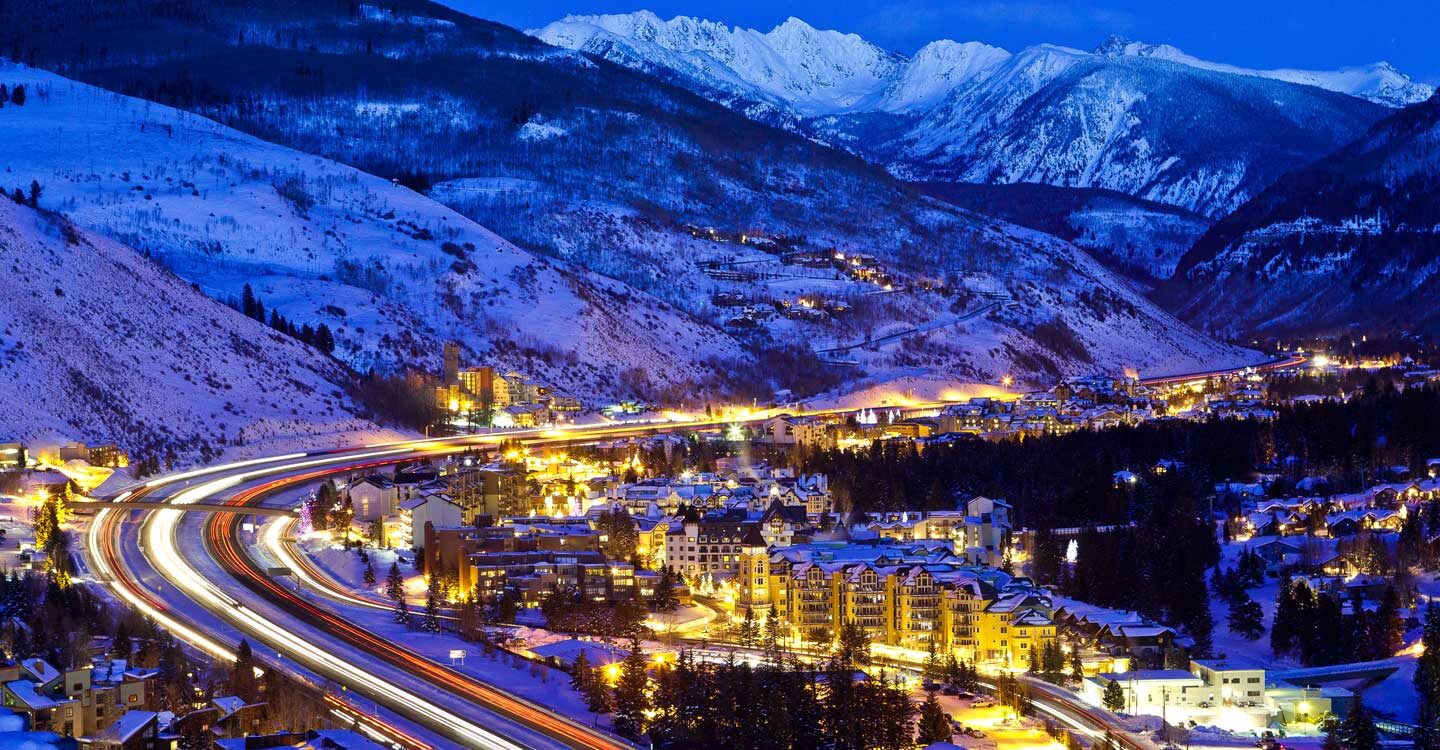 Vail lights up at night with mountains in background Tivoli Lodge Vail Colorado