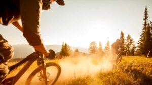 mountain bikers ride the dusty trail during GoPro Games Tivoli Lodge Vail Colorado