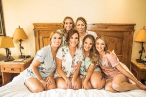 bride and bridesmaids pose before the big day in a room at the Tivoli Lodge Vail Colorado