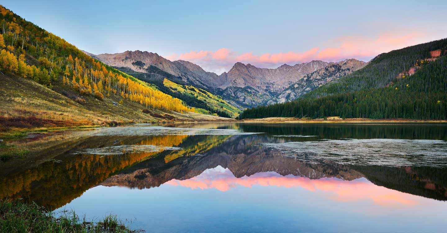 majestic view of vail mountain with lake and fall colors Tivoli Lodge Vail Colorado