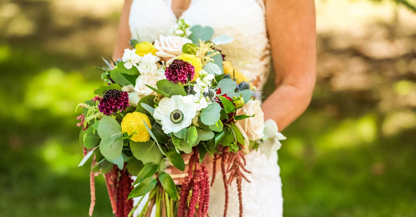 bride holds bouquet before her wedding Tivoli Lodge Vail Colorado