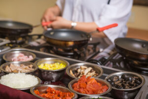 chef prepares custom omelet with many ingredients Tivoli Lodge Vail Colorado