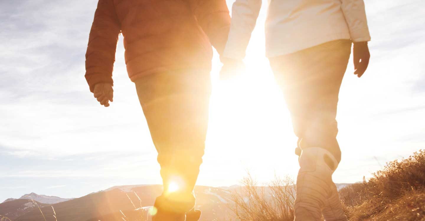 couple walks along a trail in Vail at sunrise Tivoli Lodge Vail Colorado