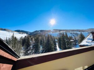 view from penthouse balcony on sunny winter day at the Tivoli Lodge Vail Colorado