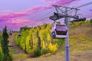 gondola rides at sunset with purple and pink sky Tivoli Lodge Vail Colorado