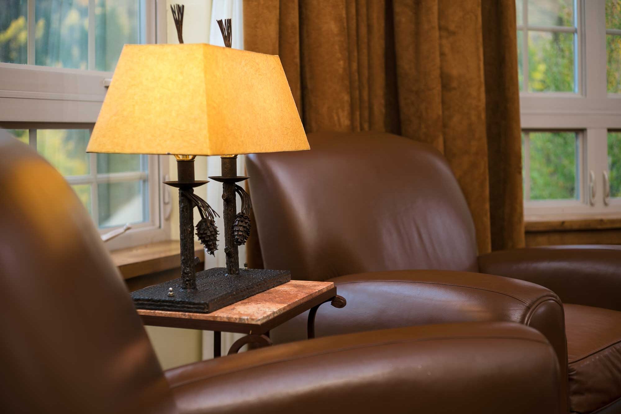 close up of Seibert suite with comfortable leather chairs and mountain decor Tivoli Lodge Vail Colorado