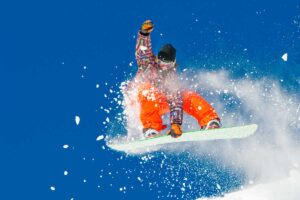 snowboarder shows off skills on mountain Tivoli Lodge Vail Colorado