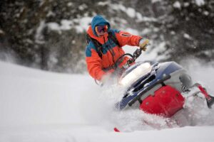 man tries to control his snowmobile on a winter day Tivoli Lodge Vail Colorado