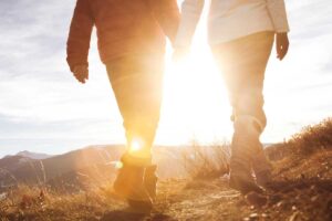 couple enjoys a hike at sunrise on a chilly morning Tivoli Lodge Vail Colorado