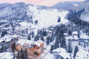 wintertime in Vail snow on mountain and Tivoli Lodge Vail Colorado in foreground