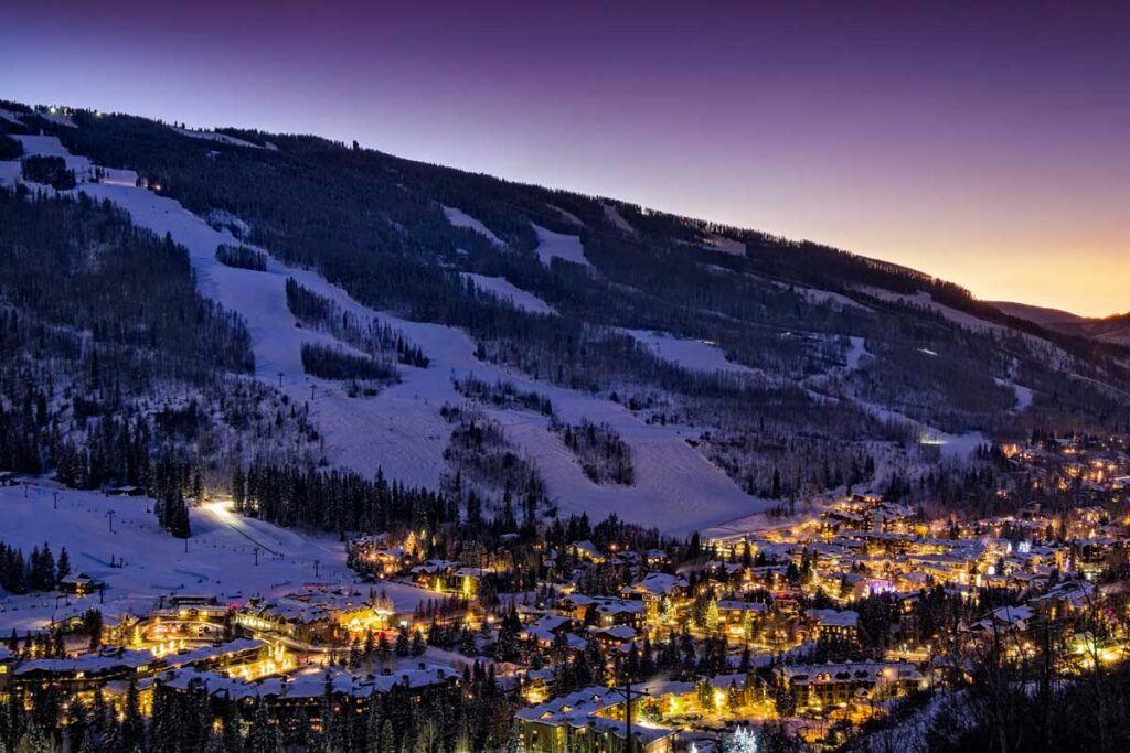 Vail lit up at sunset with view of Vail Mountain Tivoli Lodge Vail Colorado