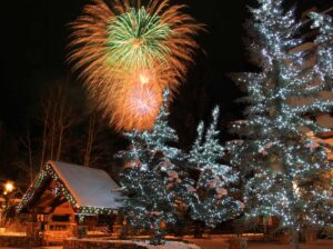 trees have lights and fireworks in the sky at Vail Village Tivoli Lodge Vail Colorado