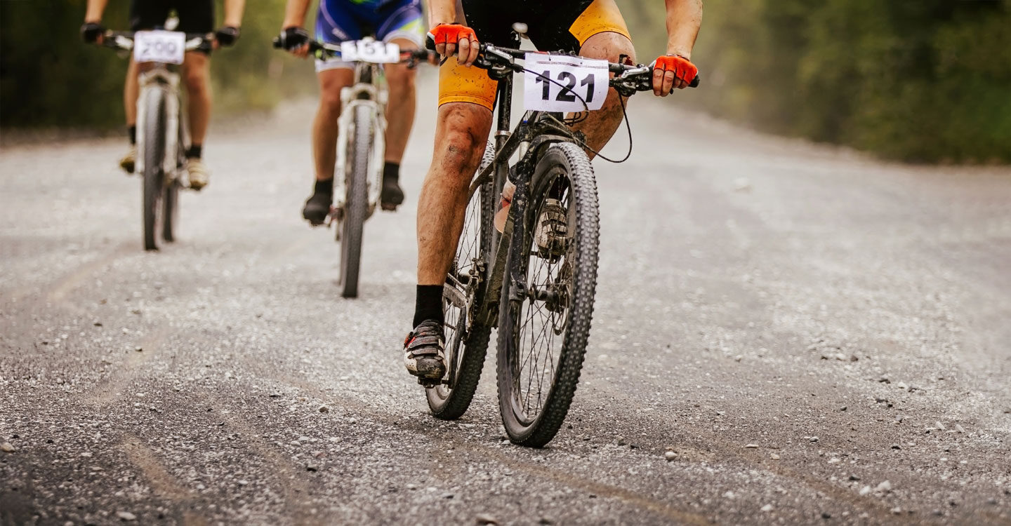three male mountain bikers get muddy during their race Tivoli Lodge Vail Colorado