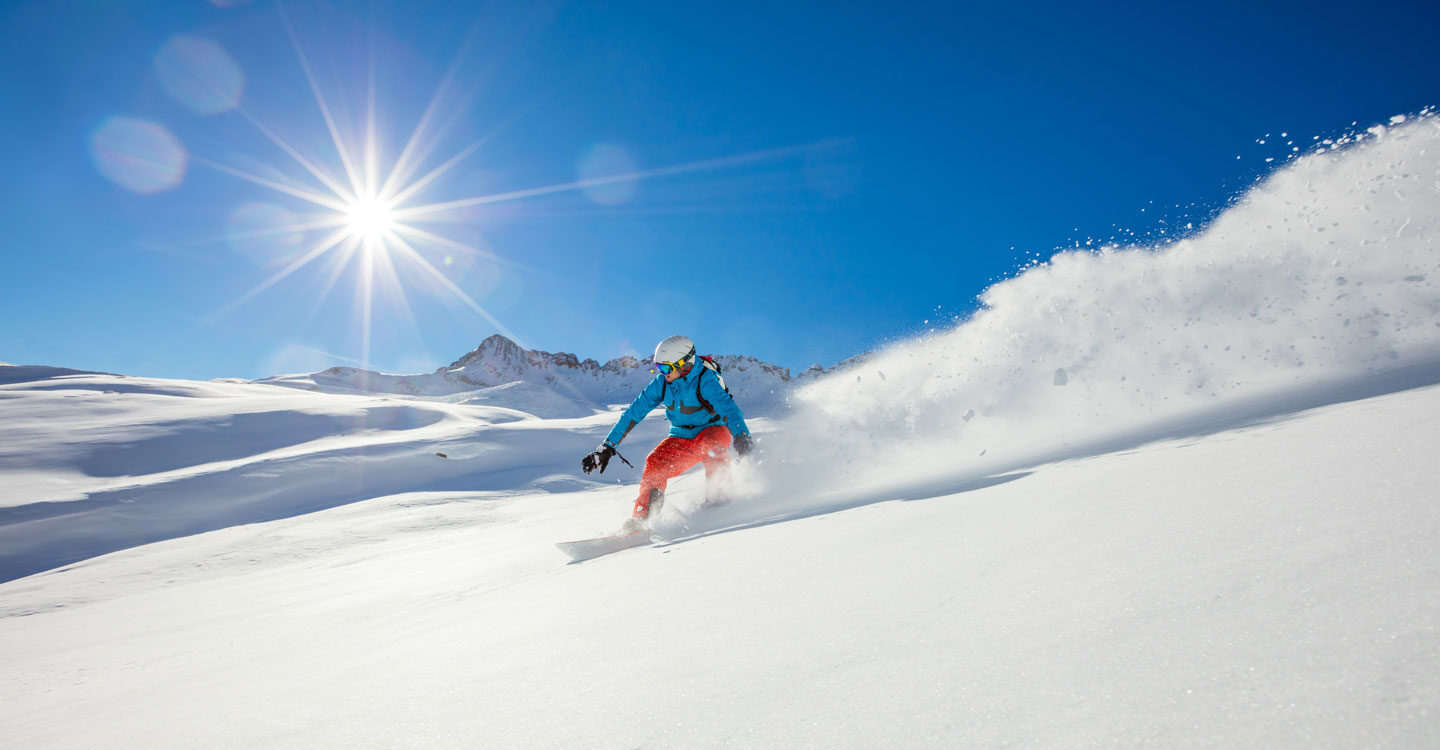 skier shows off downhill skills on a sunny winter day Tivoli Lodge Vail Colorado