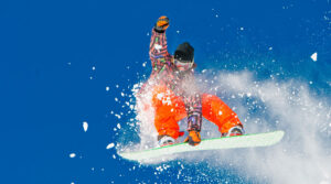 snowboarder flies high in the air during a winter run Tivoli Lodge Vail Colorado