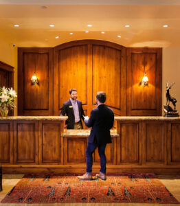 male guest at lobby checking into the Tivoli Lodge Vail Colorado