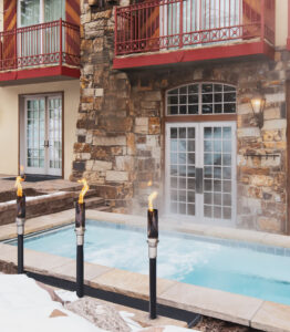 outdoor hot tub with heaters is ready for guests on a winter day Tivoli Lodge Vail Colorado